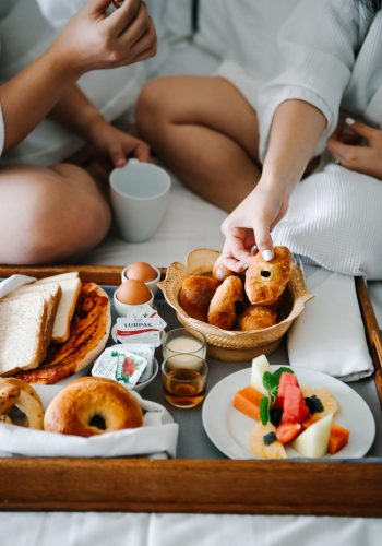 couple-eating-breakfast-on-the-bed-3575143-scaled.jpg