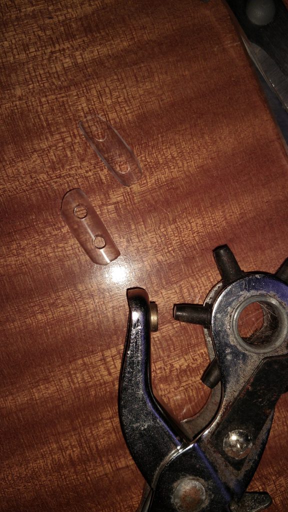 Then you punch two holes in each piece using the rotary hole punch tool