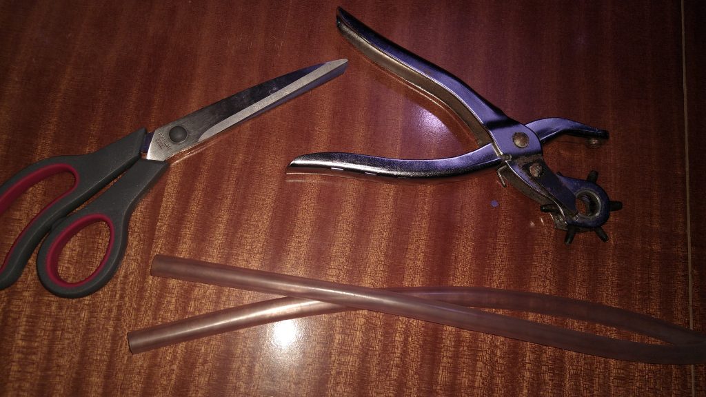All you need, a pair of scissors, a rotary hole punch tool and a piece of transparent hose (iØ 1cm)