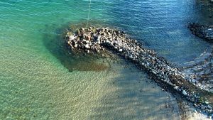 Rocky jetty and emerald water