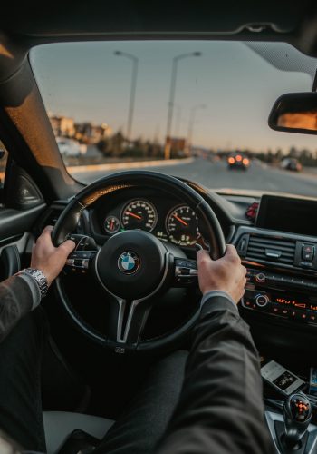 unknown person driving BMW car